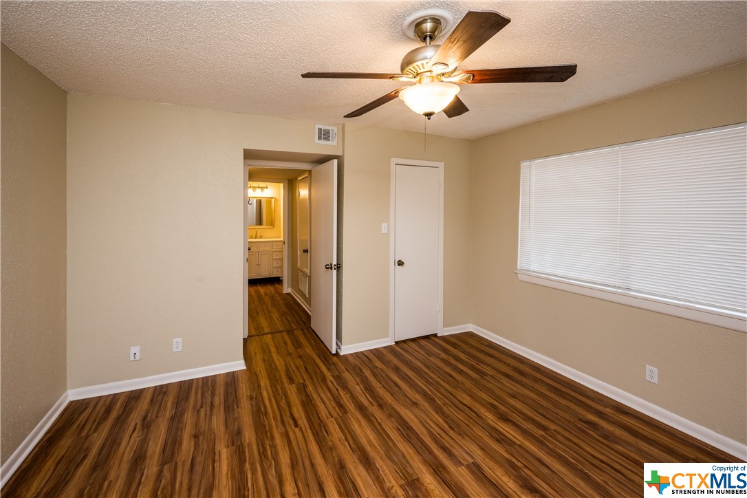 3803 Halsey Street Victoria, TX 77901 - Photo 8 of 16 a view of a room with wooden floor and a ceiling fan