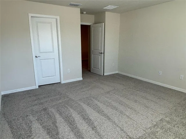 an empty room with closet area
