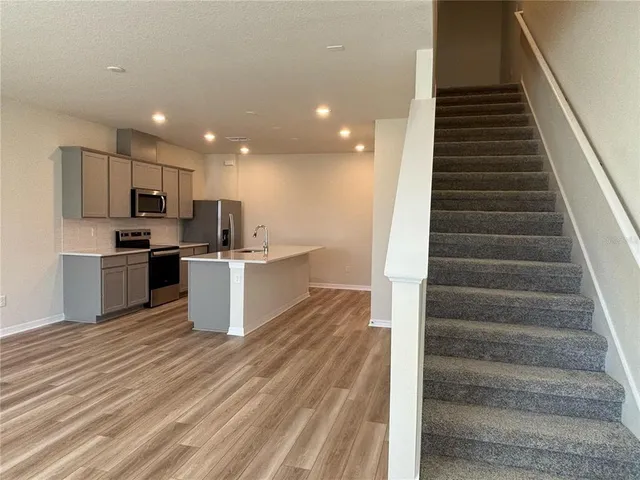 a view of kitchen with sink microwave and stove