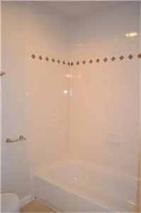 a bathroom with a bathtub and toilet