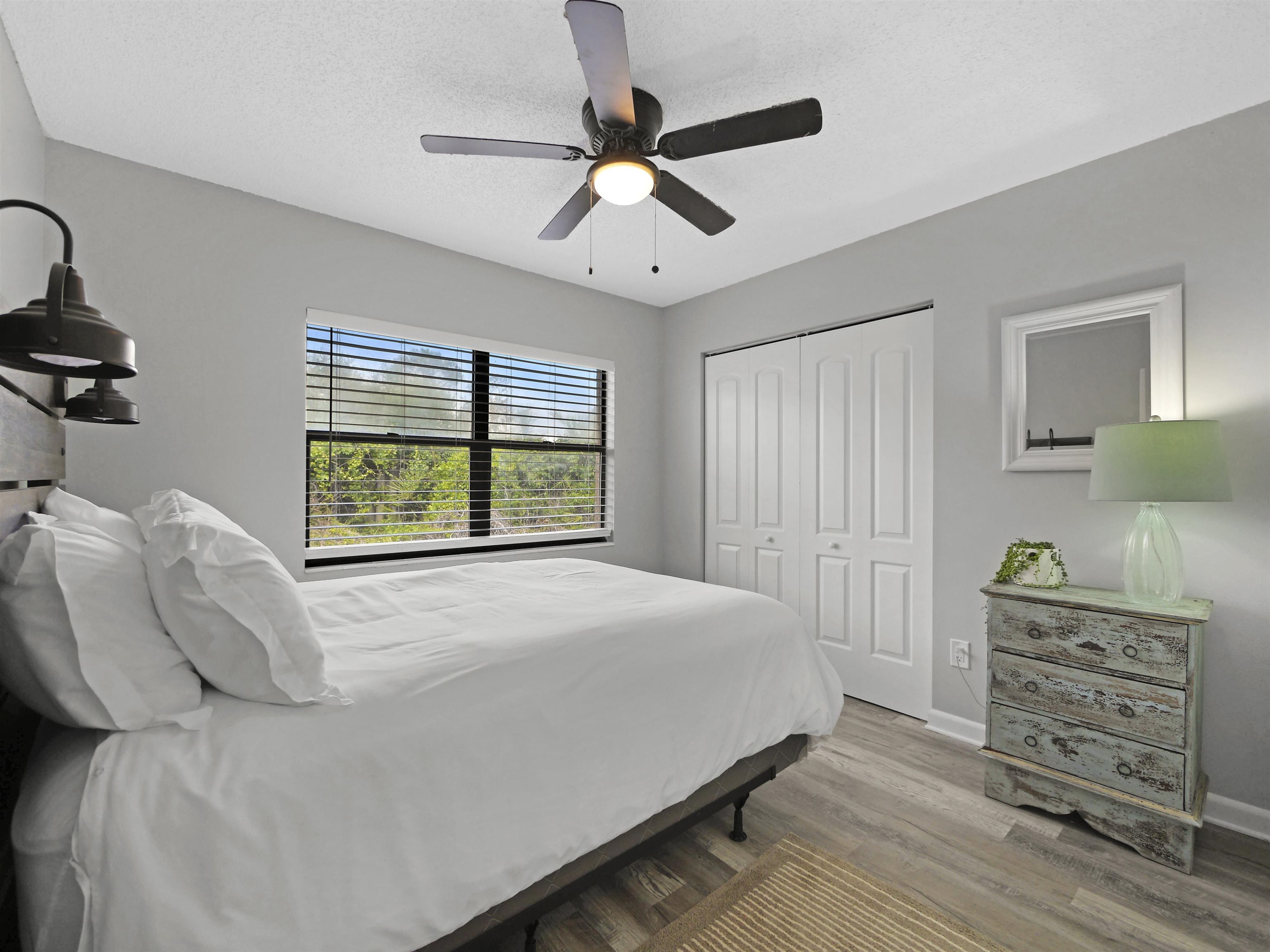 129 Rio Del Mar Street, Unit C St. Augustine, FL 32080 - Photo 14 of 26 a bedroom with a bed and a window