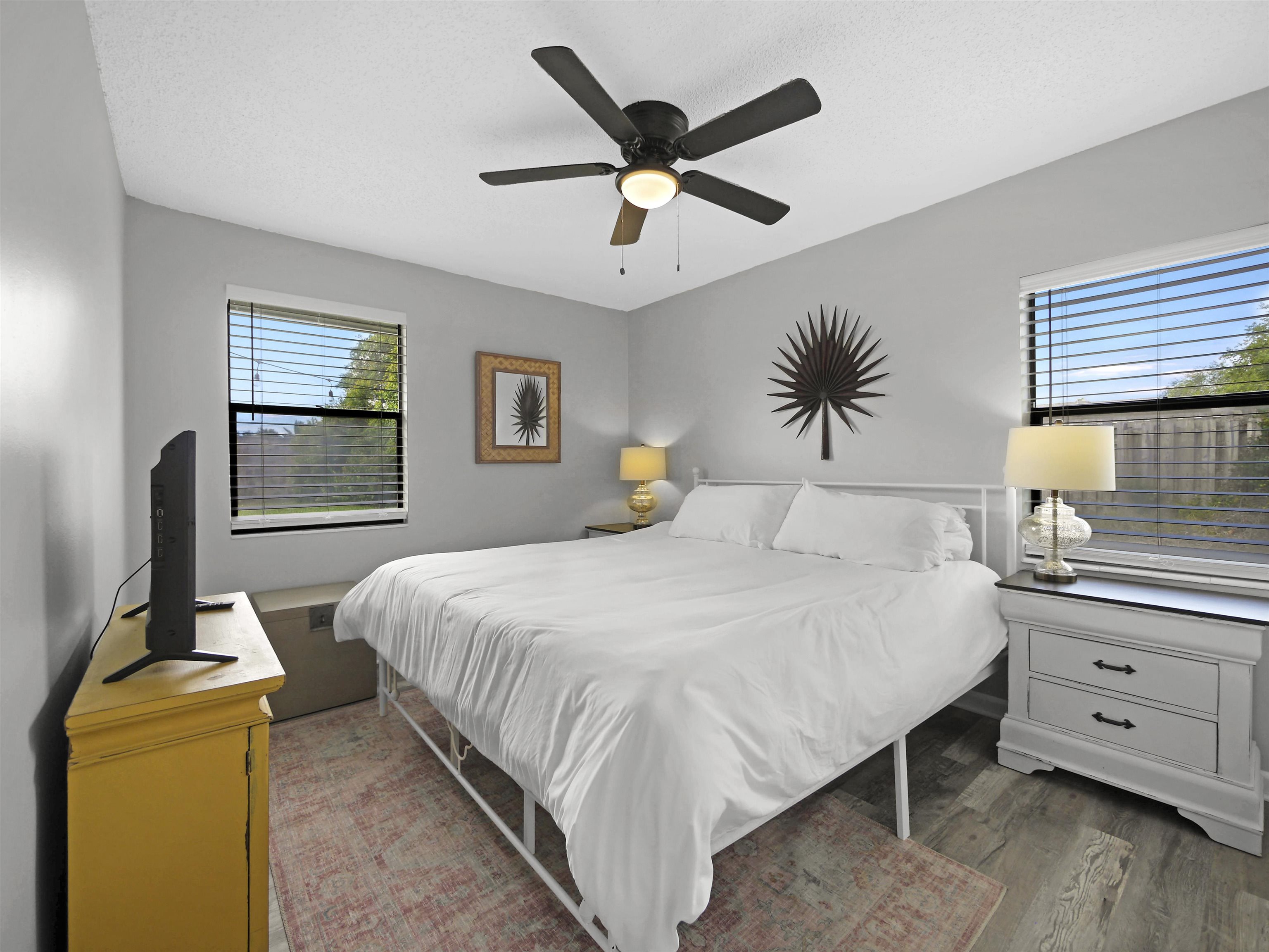 129 Rio Del Mar Street, Unit C St. Augustine, FL 32080 - Photo 17 of 26 a bedroom with a large bed and a chandelier