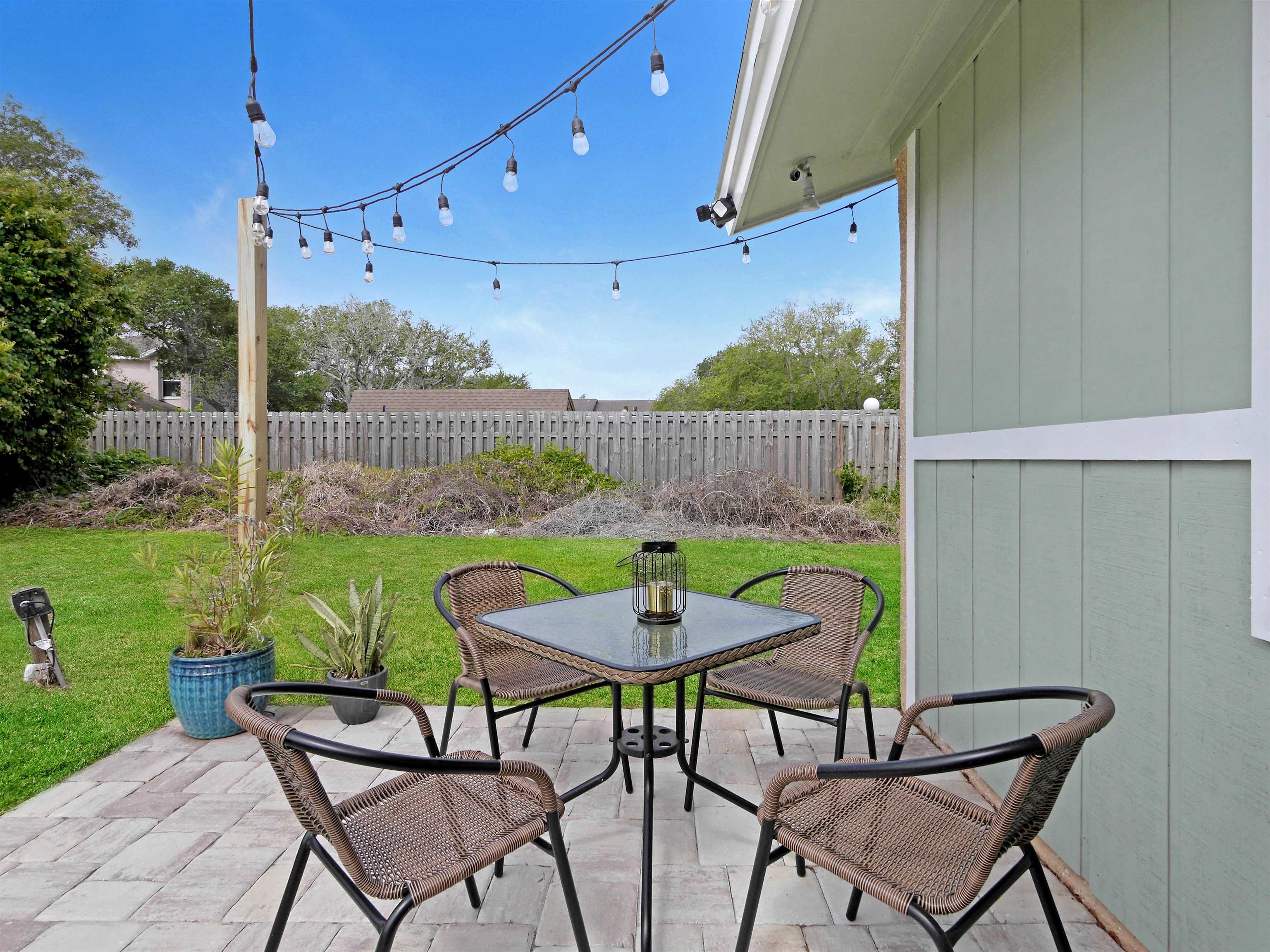 129 Rio Del Mar Street, Unit C St. Augustine, FL 32080 - Photo 22 of 26 a view of a chair and table in backyard of the house