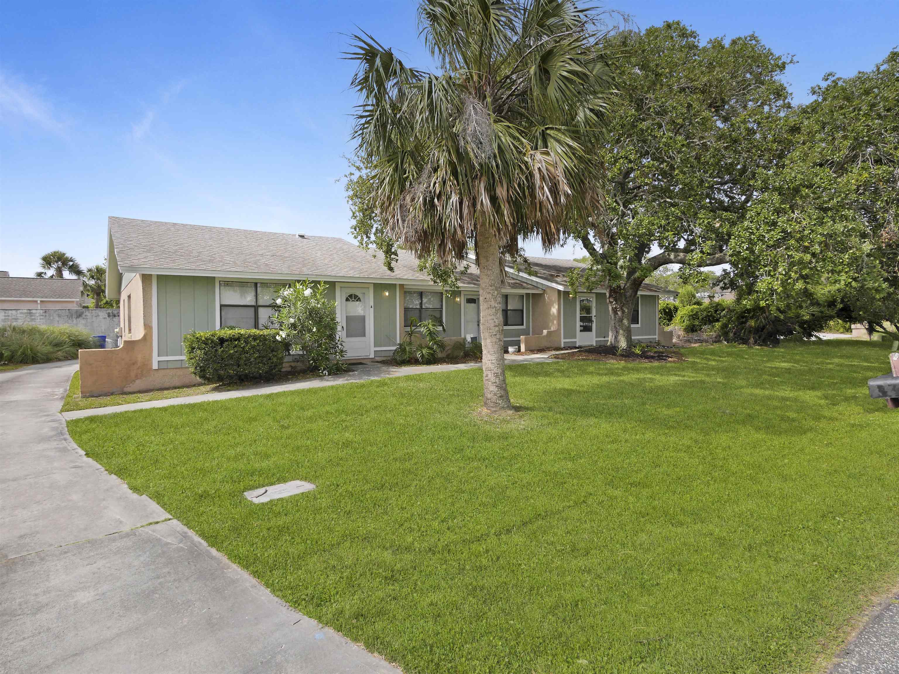 129 Rio Del Mar Street, Unit C St. Augustine, FL 32080 - Photo 26 of 26 a front view of a house with garden