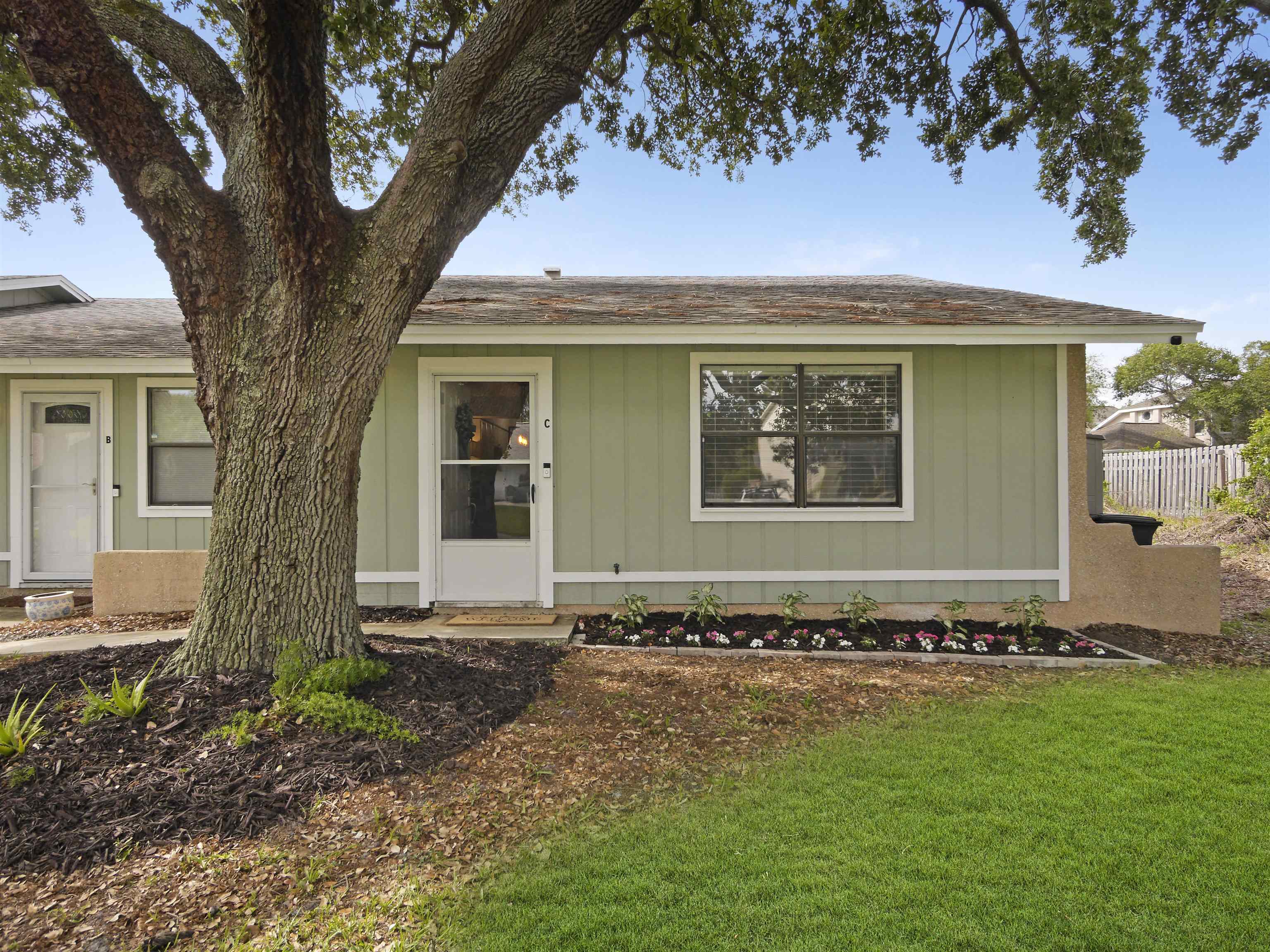 129 Rio Del Mar Street, Unit C St. Augustine, FL 32080 - Photo 3 of 26 a front view of a house with a yard
