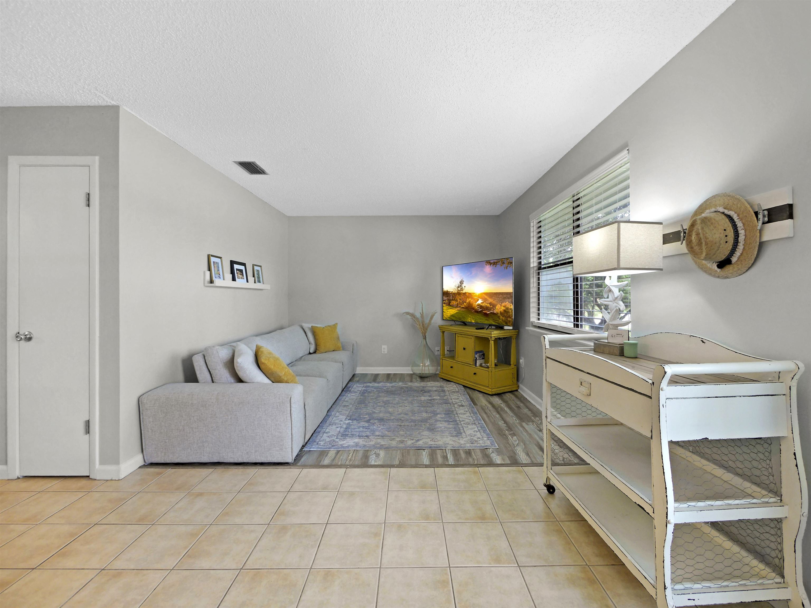 129 Rio Del Mar Street, Unit C St. Augustine, FL 32080 - Photo 5 of 26 a living room with furniture and a table