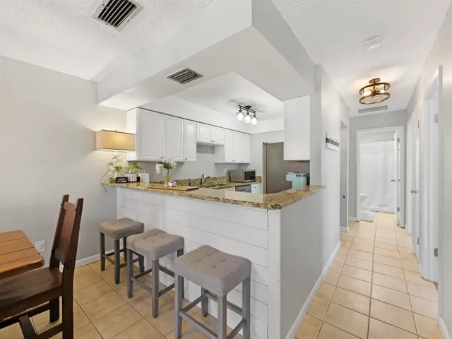 a kitchen with stainless steel appliances granite countertop a sink and cabinets