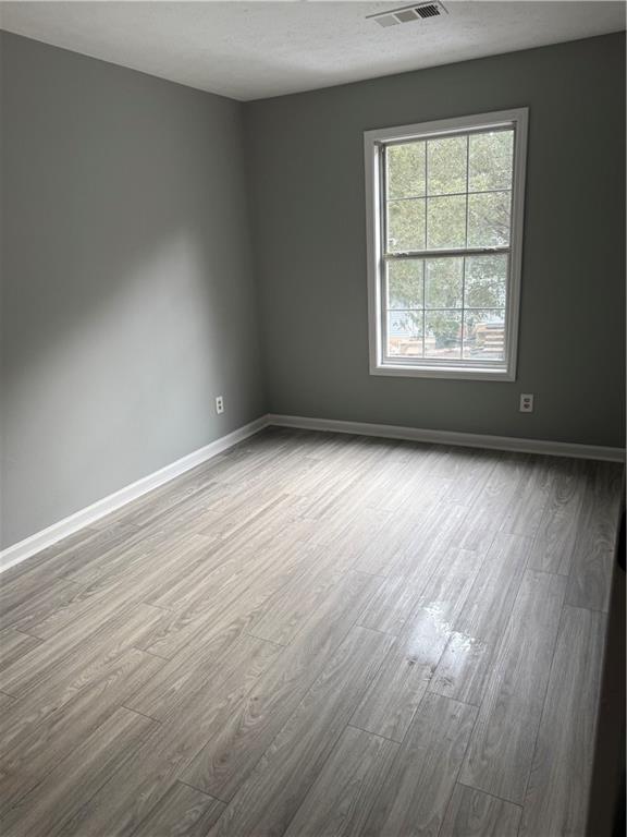 6341 Wedgeview Drive Tucker, GA 30084 - Photo 19 of 26 an empty room with wooden floor and windows