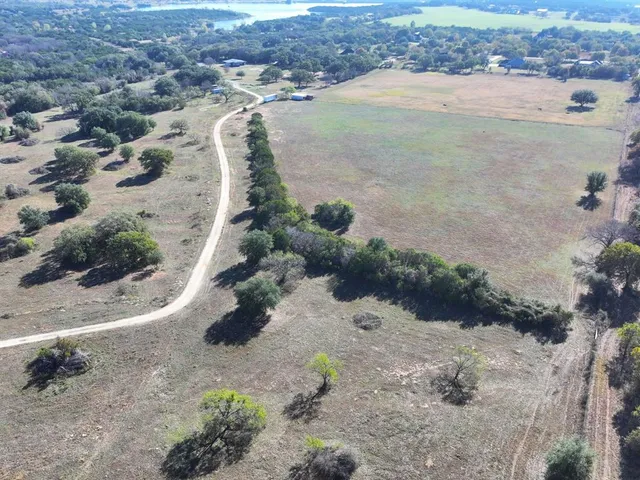 an aerial view of a house with a yard