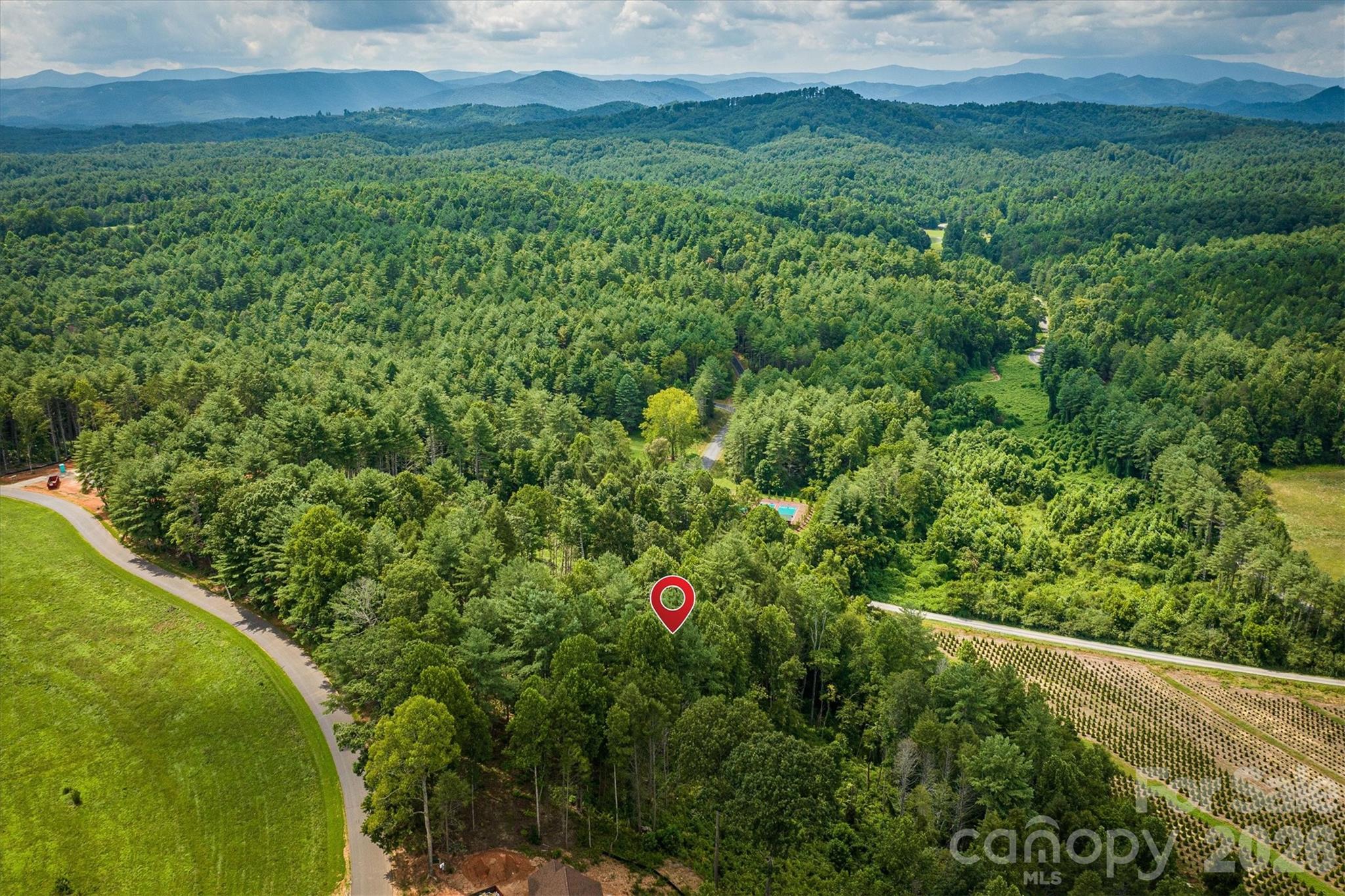 2070 Thoroughbred Way, Unit G18 Apex, NC 27523 - Photo 11 of 11 a view of a lush green field with lots of bushes