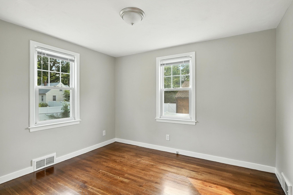 325 Hartwick Street Springfield, MA 01108 - Photo 23 of 37 an empty room with wooden floor and windows