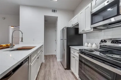 a kitchen with a sink stove and refrigerator