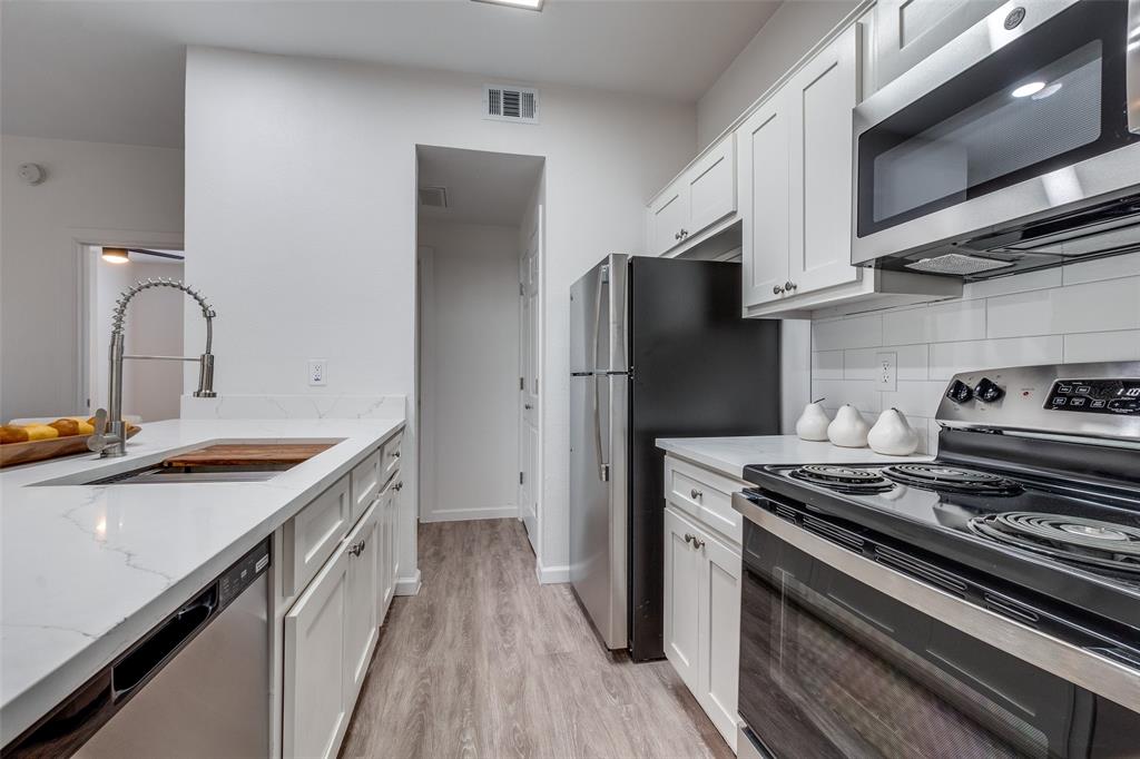 6003 Oram Street, Unit 203 Dallas, TX 75206 - Photo 13 of 25 a kitchen with a sink stove and refrigerator