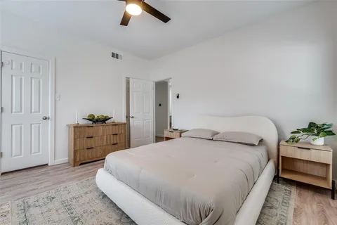a bedroom with a bed and ceiling fan