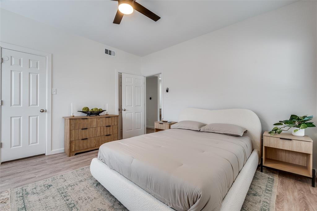 6003 Oram Street, Unit 203 Dallas, TX 75206 - Photo 18 of 25 a bedroom with a bed and ceiling fan