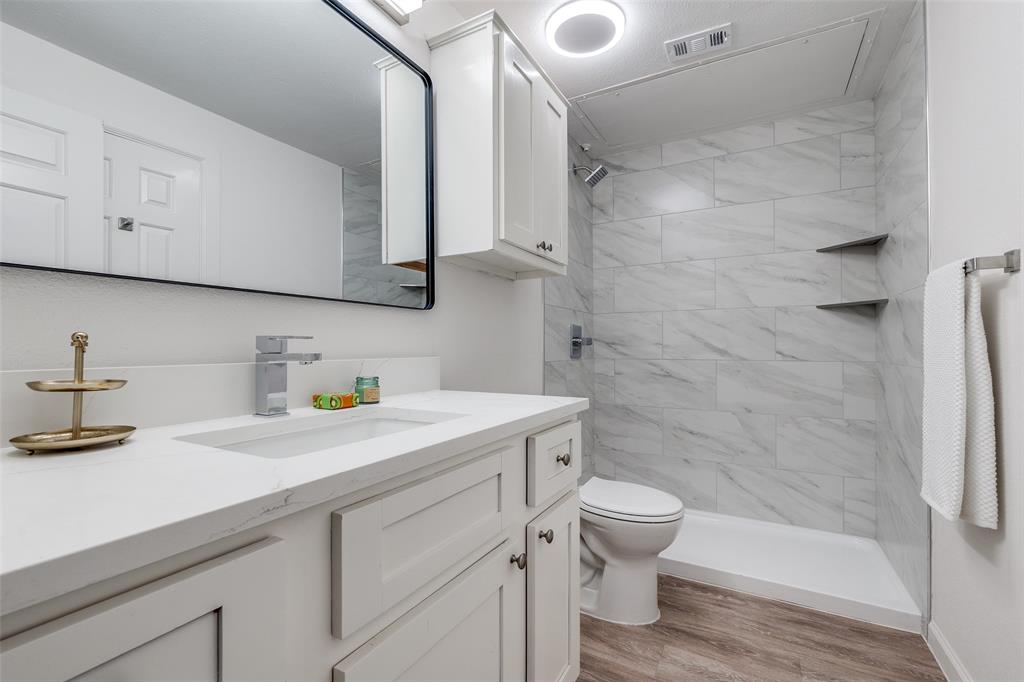 6003 Oram Street, Unit 203 Dallas, TX 75206 - Photo 19 of 25 a bathroom with a granite countertop sink toilet and shower