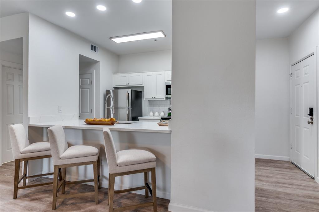 6003 Oram Street, Unit 203 Dallas, TX 75206 - Photo 8 of 25 a room with a table chairs and wooden floor