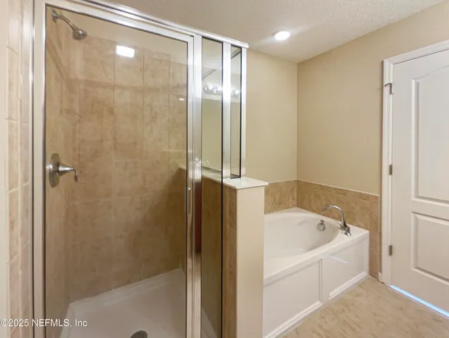 a bathroom with a bathtub and a shower