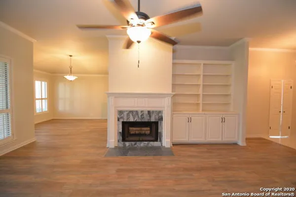 an empty room with a fireplace and fan