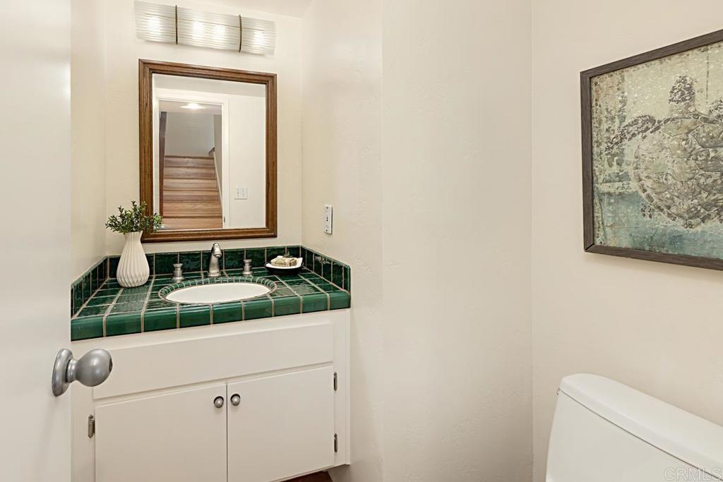 3242 Via Alicante La Jolla, CA 92037 - Photo 12 of 27 a bathroom with a granite countertop sink and a mirror