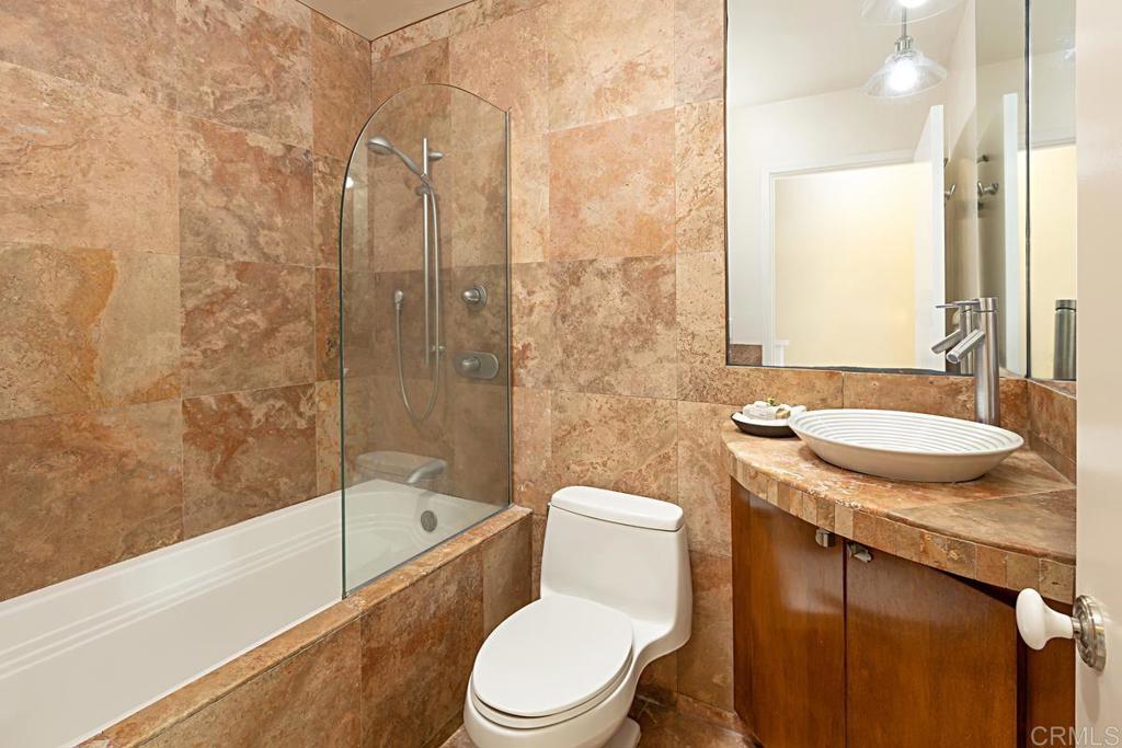 3242 Via Alicante La Jolla, CA 92037 - Photo 16 of 27 a bathroom with a granite countertop sink toilet and shower