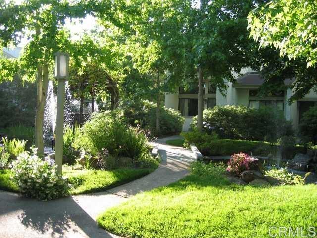 3242 Via Alicante La Jolla, CA 92037 - Photo 23 of 27 a front view of a house with a yard and a large tree