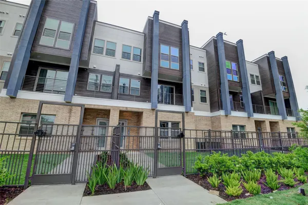 a view of a brick building next to a yard