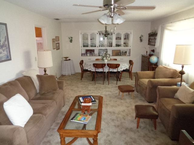 676 West Huntsman Avenue Reedley, CA 93654 - Photo 2 of 18 a living room with furniture a chandelier and a window