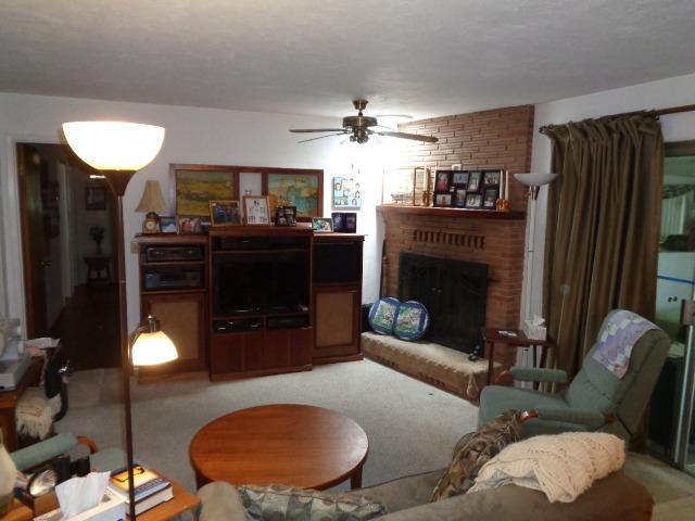 676 West Huntsman Avenue Reedley, CA 93654 - Photo 3 of 18 a living room with furniture a fireplace and a chandelier