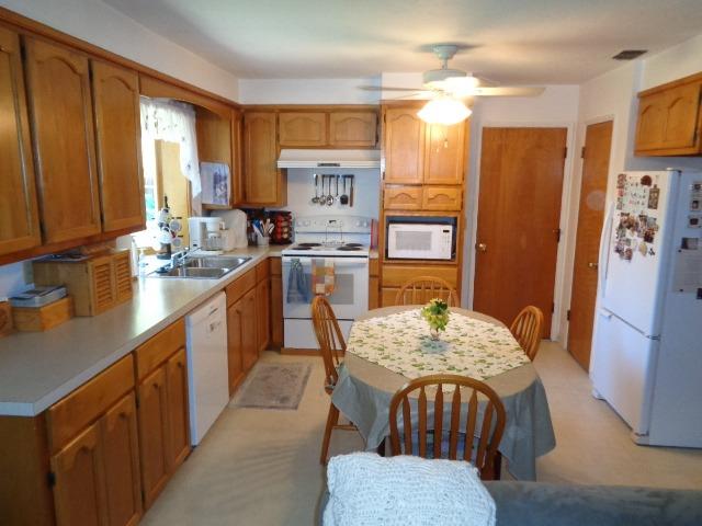 676 West Huntsman Avenue Reedley, CA 93654 - Photo 4 of 18 a kitchen with refrigerator cabinets dining table and chairs