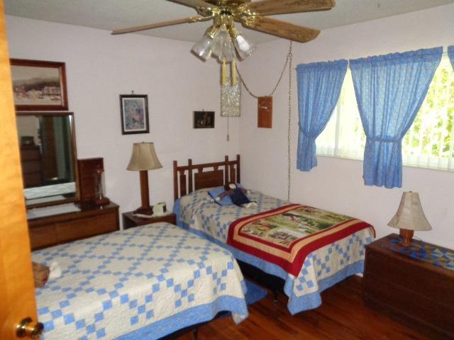 676 West Huntsman Avenue Reedley, CA 93654 - Photo 5 of 18 a bedroom with a bed and a chandelier