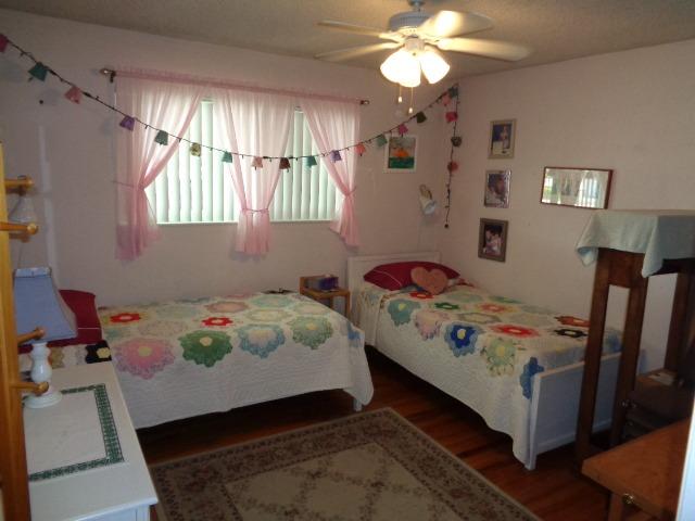 676 West Huntsman Avenue Reedley, CA 93654 - Photo 8 of 18 a bedroom with a bed and a chandelier