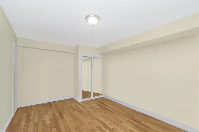 a view of an empty room and wooden floor