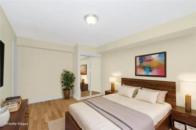 a bedroom with a bed and a potted plant