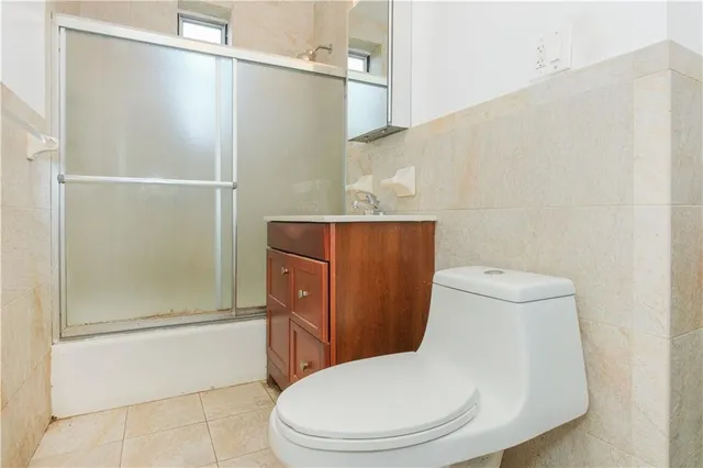 a white toilet sitting next to a bathroom sink