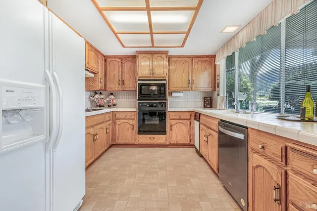 a kitchen with stainless steel appliances granite countertop a sink and cabinets