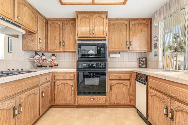 a kitchen with stainless steel appliances granite countertop a sink and cabinets