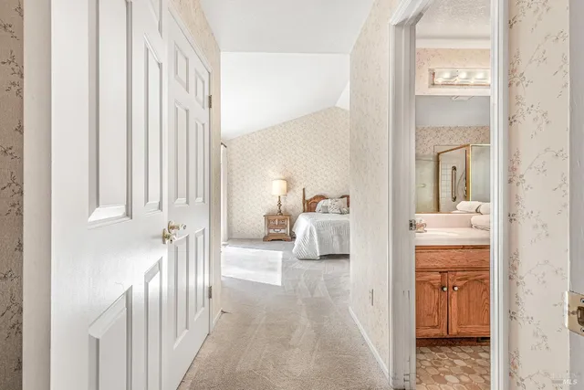 a bedroom with a bed chair and large window