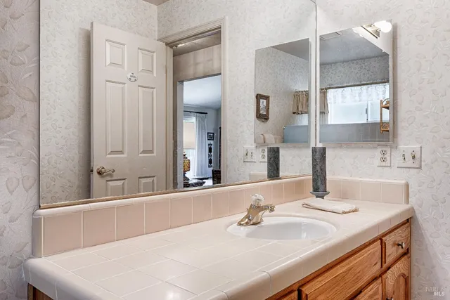 a bedroom with two beds and a lamp