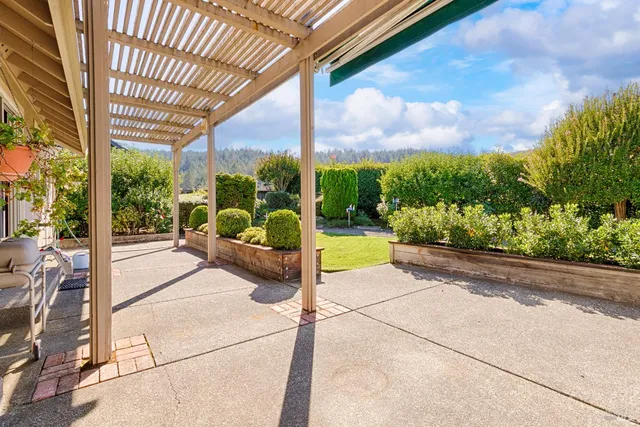 a front view of a house with a yard garden and outdoor seating