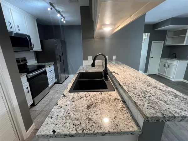 a kitchen with a stove and a sink