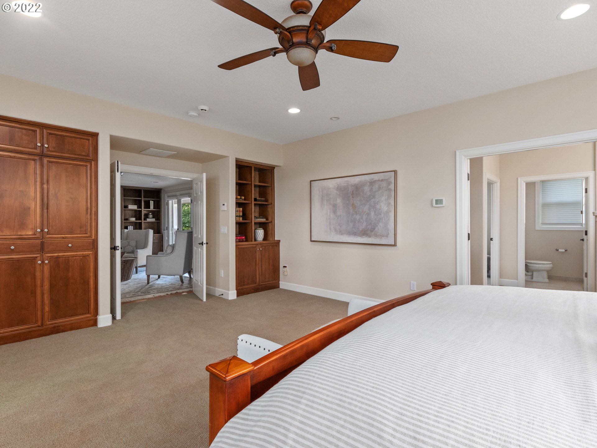 3515 Northwest 221st Street Ridgefield, WA 98642 - Photo 14 of 32 a bedroom with a large bed and a chandelier