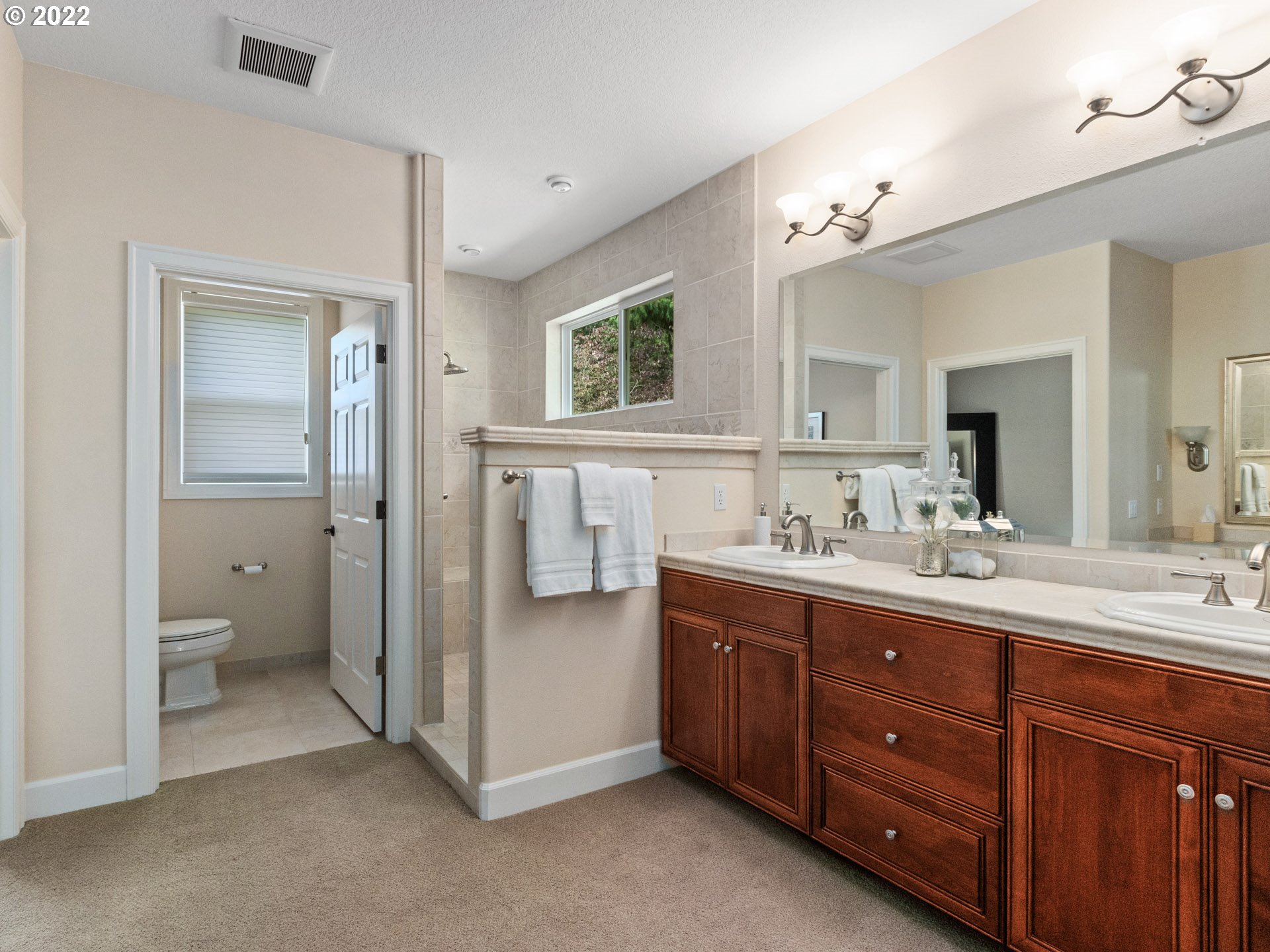 3515 Northwest 221st Street Ridgefield, WA 98642 - Photo 15 of 32 a spacious bathroom with a double vanity sink a mirror and a shower