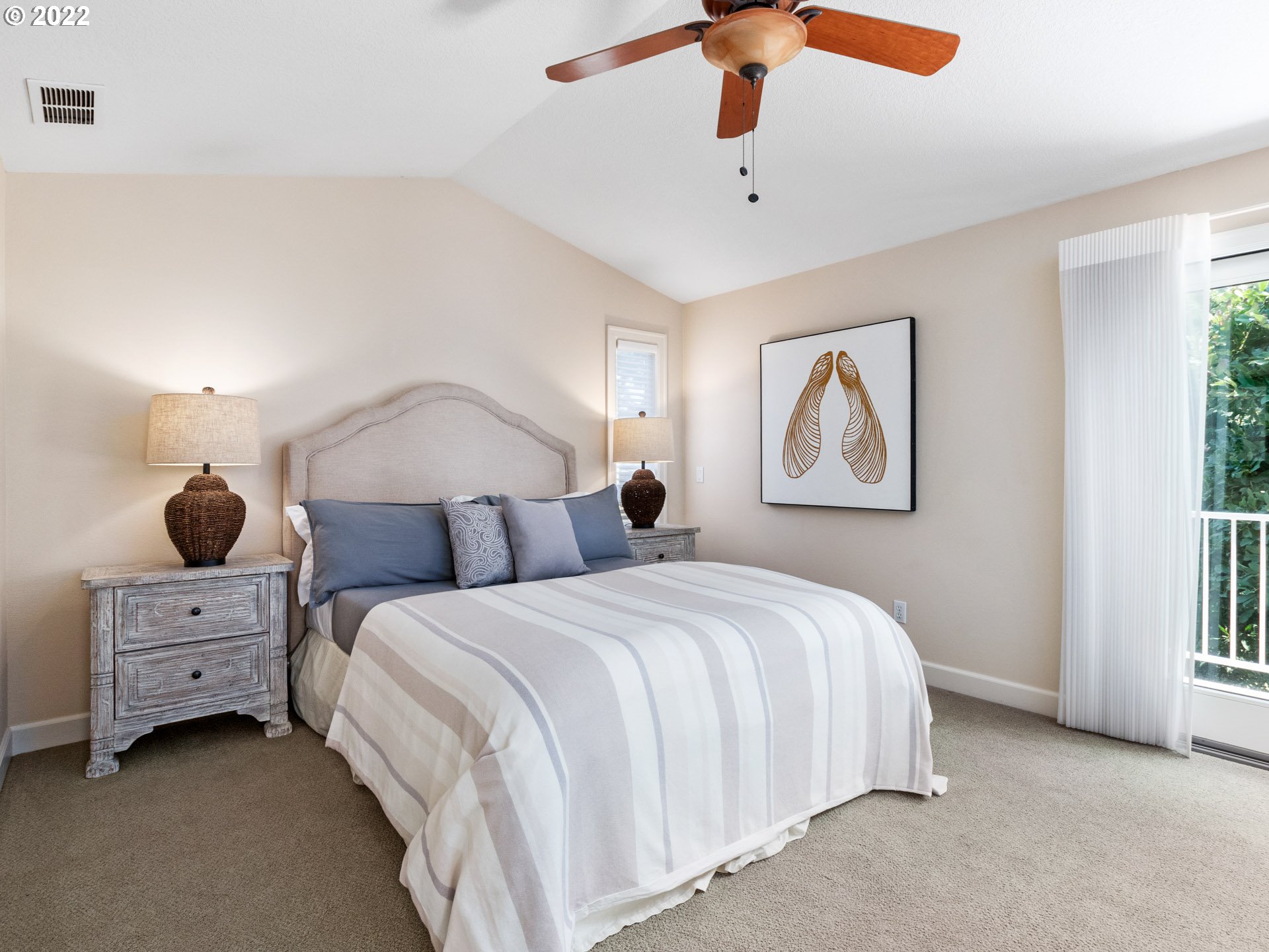 3515 Northwest 221st Street Ridgefield, WA 98642 - Photo 18 of 32 a bedroom with a bed and a chandelier