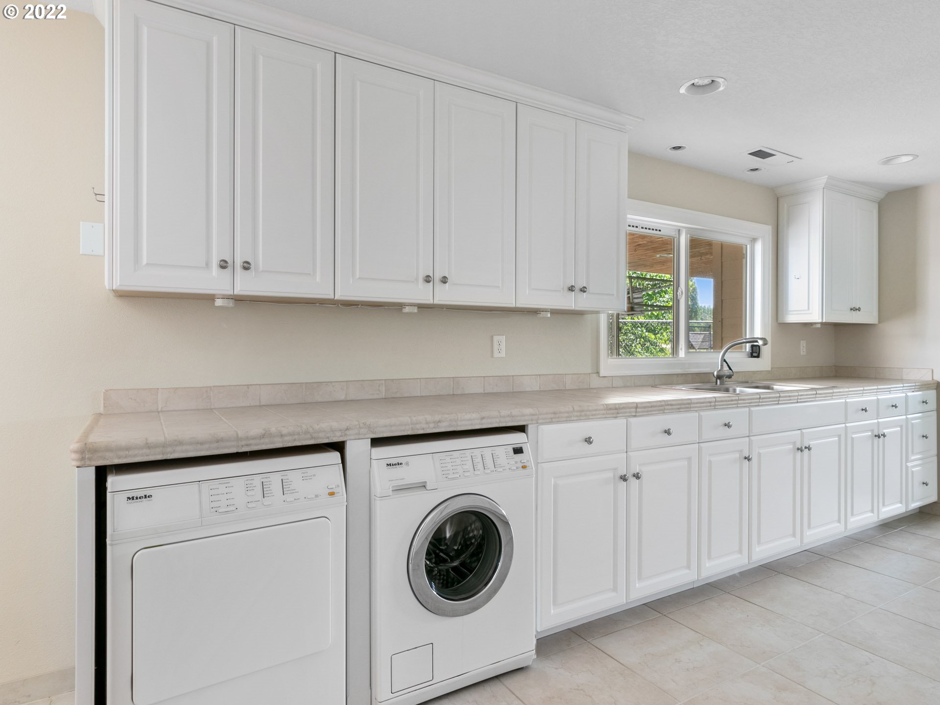 3515 Northwest 221st Street Ridgefield, WA 98642 - Photo 21 of 32 a kitchen with granite countertop white cabinets and a sink