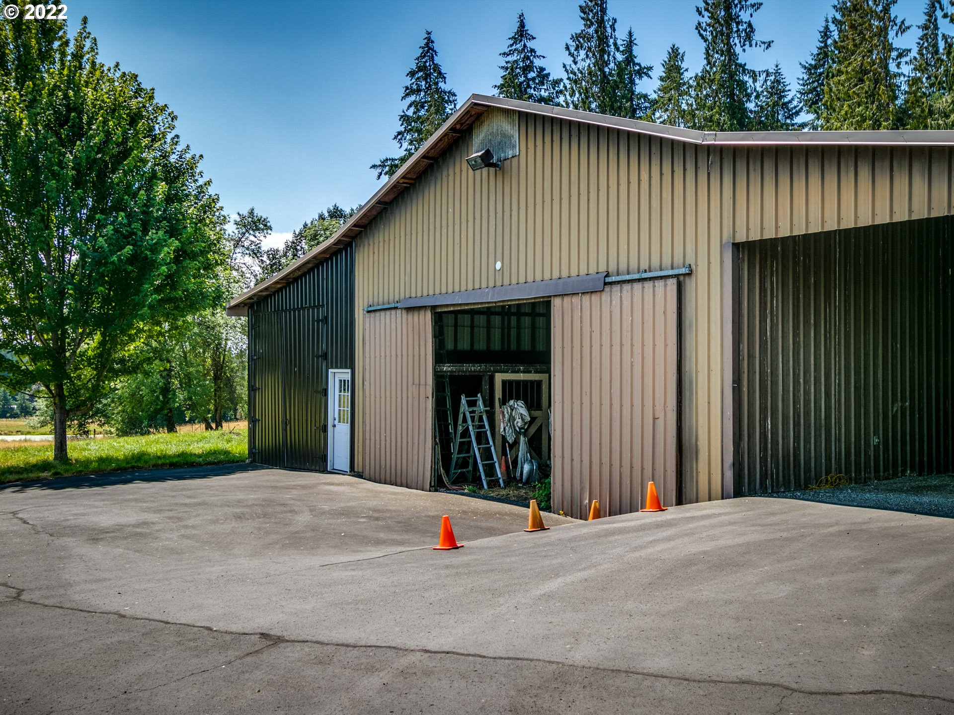 3515 Northwest 221st Street Ridgefield, WA 98642 - Photo 29 of 32 a view of a house with a backyard and a garage