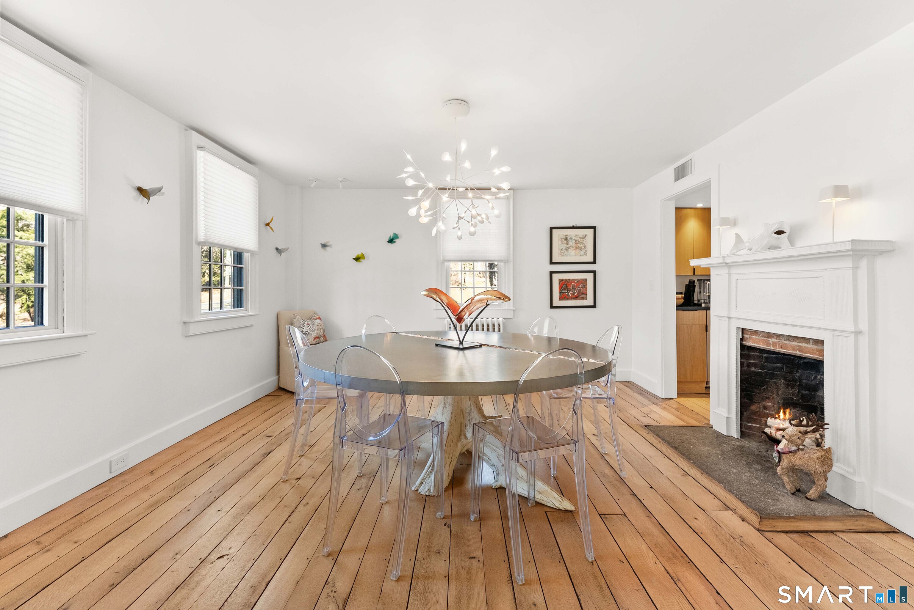 382 Weekeepeemee Road Woodbury, CT 06798 - Photo 22 of 40 a view of a livingroom with furniture a fireplace wooden floor and chandelier