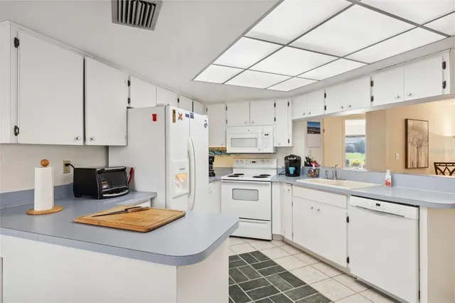 a bedroom with a bed and a flat tv screen next to a large window