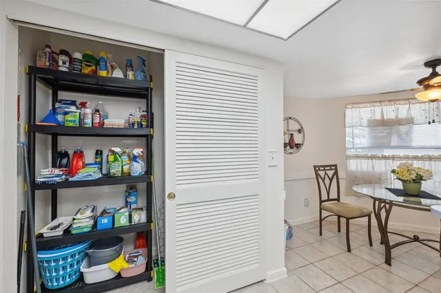 a dining room with furniture and a floor to ceiling window
