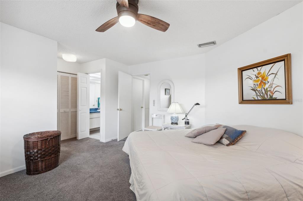 3942 Trophy Boulevard New Port Richey, FL 34655 - Photo 31 of 78 a bedroom with a bed and a chandelier